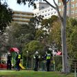 Police stand guard outside a public housing estate locked down in Melbourne due to a spike in coronavirus cases