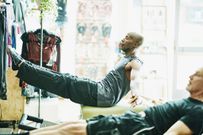 Mature men using pilates reformer while exercising during class in fitness studio