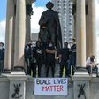 Protesters climb a statue of John A. Macdonald, Canada's first prime minister, during a march against police brutality and racism in Montreal on June 7. Thousands have signed a petition to have the statue removed.