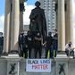 Protesters climb a statue of John A. Macdonald, Canada's first prime minister, during a march against police brutality and racism in Montreal on June 7. Thousands have signed a petition to have the statue removed.