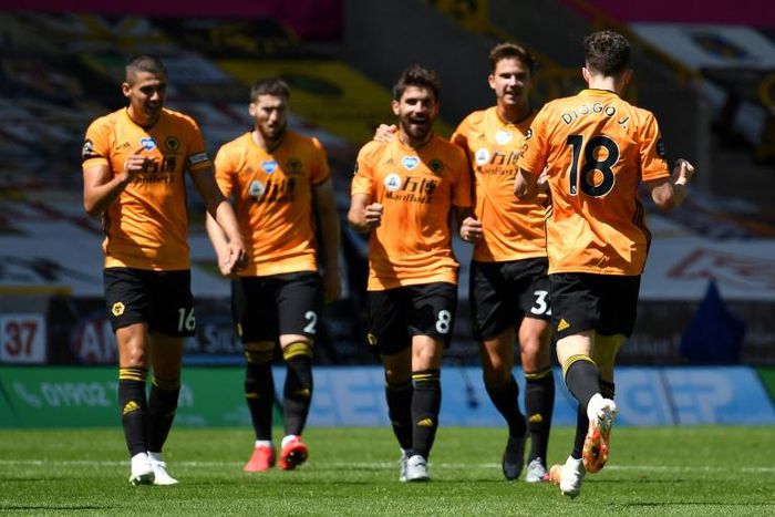 Happy pack of Wolves: Diogo Jota (right)celebrates after scoring Wolves' third goal in a 3-0 win over Everton