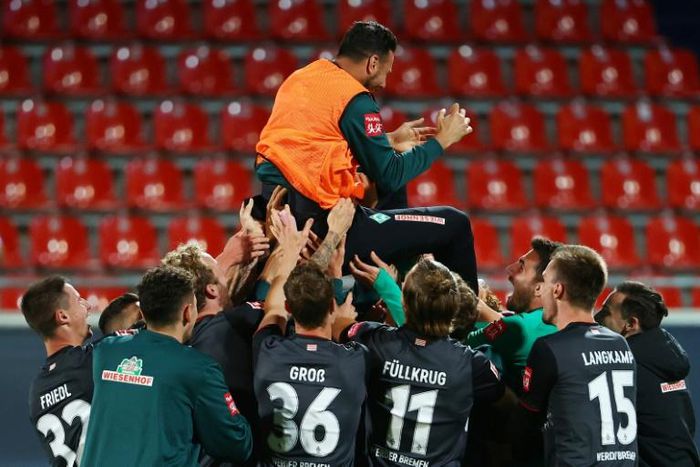BClaudio Pizarro, 41, is cheered by his Werder Bremen team-mates as he retired after their relegation/promotion play-off on Monday at Heidenheim.