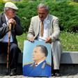Two admirers reminisce about the late Yugoslav communist president Josip Broz Tito, commemorated in the portrait