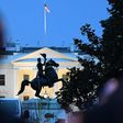 Police officers guard the statue of former US President Andrew Jackson just outside the White House after protesters tried to topple it