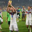 Germany forward Andre Schuerrle holds up the World Cup trophy in Rio de Janeiro after Germany won the final of Brazil 2014.