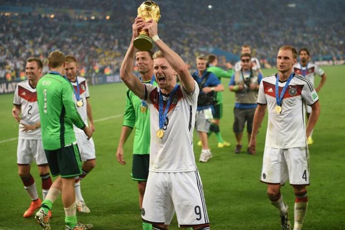 Germany forward Andre Schuerrle holds up the World Cup trophy in Rio de Janeiro after Germany won the final of Brazil 2014.