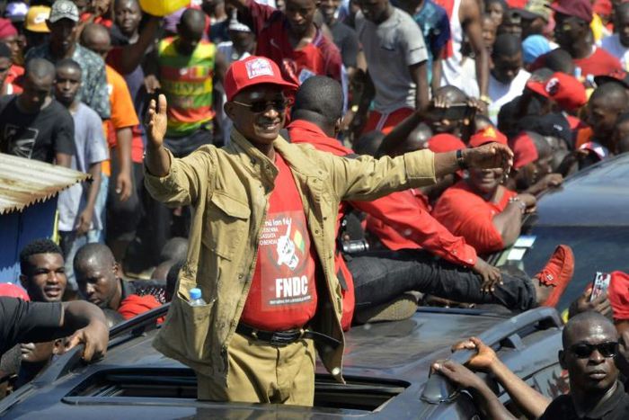 Cellou Dalein Diallo waves to the crowd at a protest against the third term of President Alpha Conde