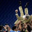 Napoli's players throw club President Aurelio De Laurentiis in the air as they celebrate after the Italian Cup trophy.