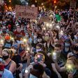 Protestors in Washington hold up their phones at a march on June 3