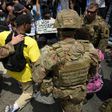 Protesters and members of the Army National Guard kneel together in Los Angeles on June 2, 2020 during a demonstration over the killing of George Floyd