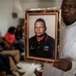 A spokesperson for bereaved relatives holds a portrait of Anastacio Matavele, an election monitor who was gunned down ahead of a key vote last October