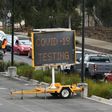 A long queue of cars wait at a drive-through COVID-19 testing site in Melbourne