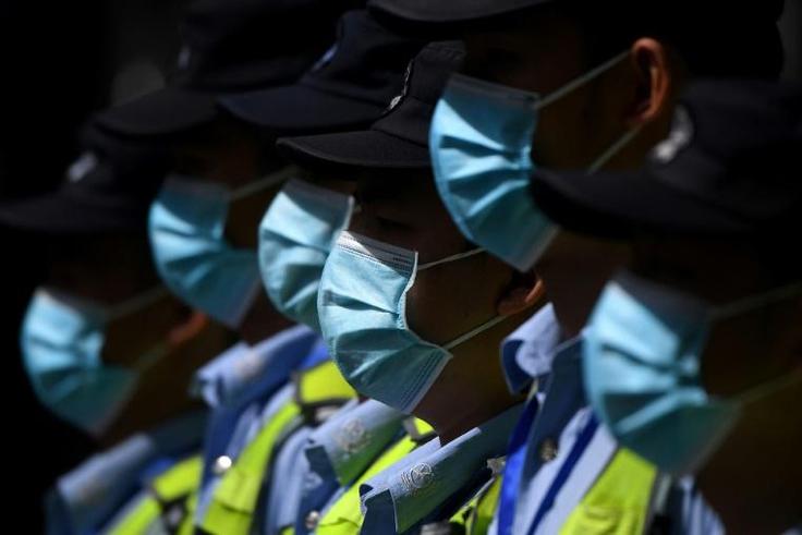 Masked police in front of the shuttered US consulate in Chengdu