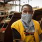 Masked: A phone credit salesman wears a dishcloth to cover his face at Kaveza market in Kigila. The country is in lockdown, and only essential stores are open.