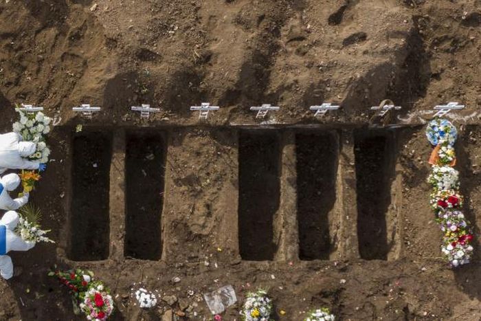A COVID-19 victim is buried at the General Cemetery in Santiago, Chile