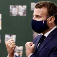 President Emmanuel Macron sporting a mask adorned with the red, white and blue of the French flag during a school visit.