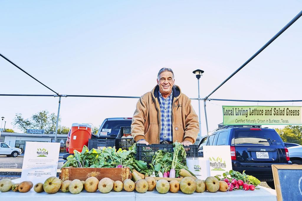 Gregory Joel, farm manager of Opals Farm at his booth during the weekly Cowtown Farmers Market.