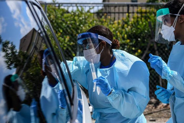 Medical personnel take samples at a "drive-thru" coronavirus testing lab set up by local community centre in West Palm Beach, north of Miami