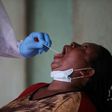 Open wide: A health worker takes a swab during a coronavirus test campaign in the Nigerian capital Abuja