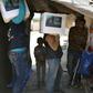 Volunteers deliver aid at a camp for displaced Syrians near the town of Deir al-Ballut in Aleppo province, by the border with Turkey, April 14, 2020 during the coronavirus pandemic