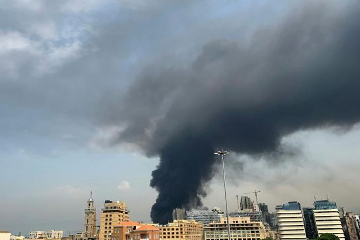 A huge column of black smoke billows into the sky over Beirut as the city's port is again engulfed by fire just weeks after a devastating dockside explosion