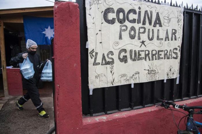 A volunteer at the "Women Warriors" soup kitchen helps feed some of Chile's neediest