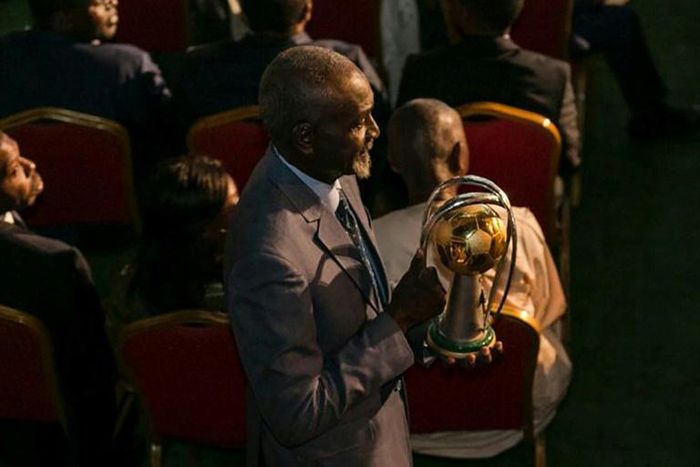 Stephen Tataw carries the trophy of the African Championship of Nations (CHAN) to the stage during the draw ceremony in Yaounde in February