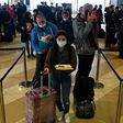 Ukrainian seasonal workers wait in line to check in for a flight to Finland where they can earn much more than at home as the coronavirus pandemic ravages the economy
