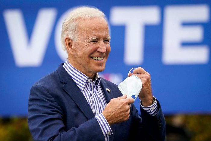 Democratic presidential nominee Joe Biden takes off his face mask to speak during a drive-in campaign rally at Bucks County Community College on October 24, 2020 in Bristol, Pennsylvania.