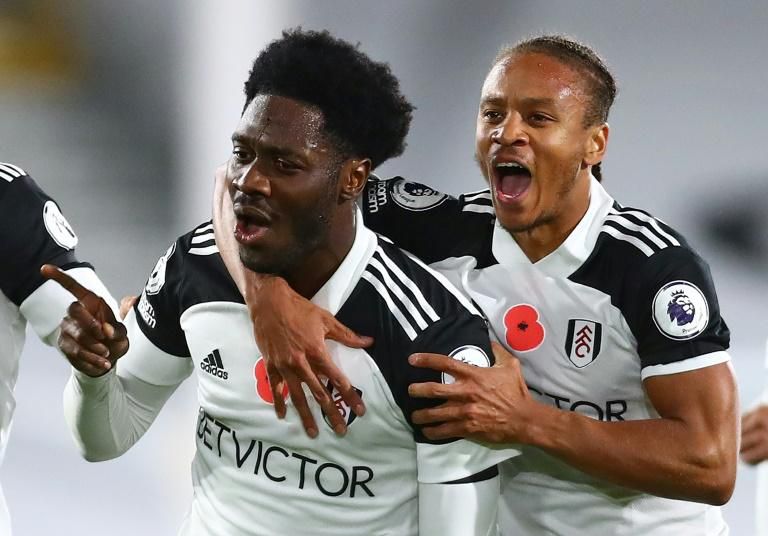 Fulham's Ola Aina (L) celebrates scoring against West Brom