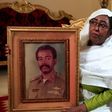 Awatef Mirghani holds a portrait of her brother Esmat, a Sudanese officer who was executed following the 1990 coup attempt