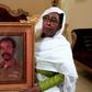 Awatef Mirghani holds a portrait of her brother Esmat, a Sudanese officer who was executed following the 1990 coup attempt