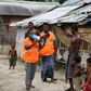 A volunteer urges residents to evacuate to shelters on May 19 ahead of the expected landfall of Super Cyclone Amphan in Khulna, Bangladesh