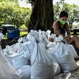 A woman prepares sand bags for the residents of Palmetto Bay near Miami as Florida prepares for the impact of Isaias