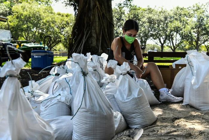 A woman prepares sand bags for the residents of Palmetto Bay near Miami as Florida prepares for the impact of Isaias