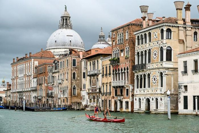 Gondoliers in Venice practise on the Grand Canal as they wait for tourists to return to the city