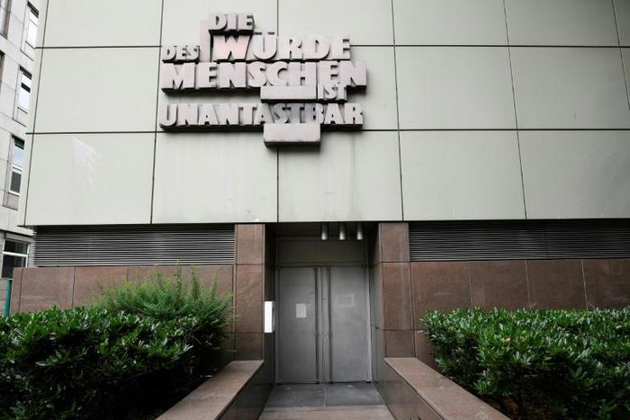 The words 'Human dignity is inviolable' stand above the entrance to a court room at the Higher Regional Court in Frankfurt, where Stephan Ernst will stand trial