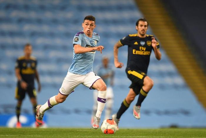 Manchester City's Phil Foden (centre) in action against Arsenal
