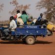 People flee with their belongings after a jihadist attack in rural northern Burkina Faso in April. Nearly a million people have been displaced