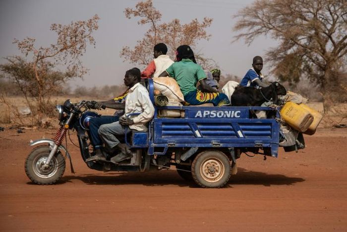 People flee with their belongings after a jihadist attack in rural northern Burkina Faso in April. Nearly a million people have been displaced