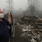 Margi Wyatt stands in front of her incinerated mobile home