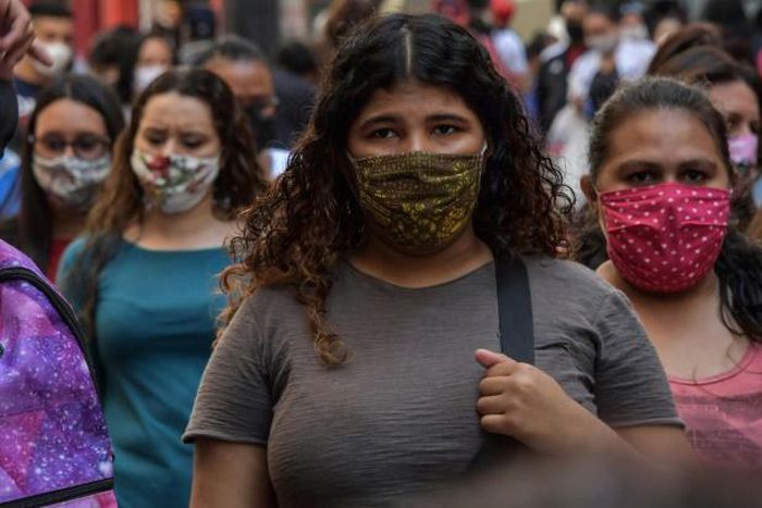 People walk along a commercial street, in downtown Sao Paulo, Brazil on August 4, 2020, amid the new coronavirus pandemic