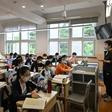 Students wear face masks in a classroom as school reopens in Shanghai