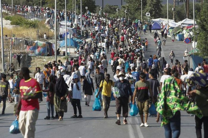 Hundreds of migrants have reluctantly made their way to the new site in the searing heat