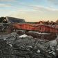 A railroad boxcar filled with ammonium nitrate lays on its side near to the remains of the fertilizer plant that exploded on April 18, 2013 in West, Texas