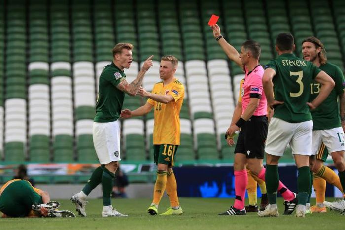 Republic of Ireland winger midfielder James McClean (2L) was sent off against Wales