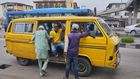 A Lagos bus driver places the mask below his nose as he 'shadows' passengers (Pulse)