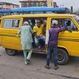 A Lagos bus driver places the mask below his nose as he 'shadows' passengers (Pulse)
