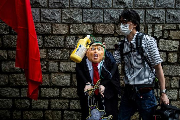 A pro-China activist holds an effigy of President Donald Trump outside the US consulate in Hong Kong in May 2020 after he announced restrictions on Chinese students