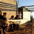 Nancy Jofre helps her four children with their homework near San Jose in the Lavalle desert area of Argentina's Mendoza province